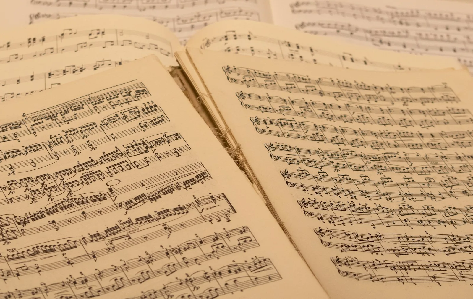 Open pages of printed sheet music on warm cream paper.